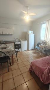a kitchen and dining room with a table and a kitchen with a refrigerator at Apto Centro Floripa 03 in Florianópolis