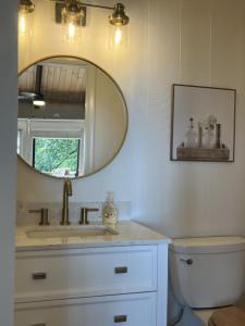 a bathroom with a sink and a mirror at Remarkable Mountain Escape! Breathtaking Views & Pet Friendly! in Hillsville +17 photos