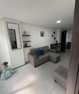 a living room with a couch and a table at alojamientos la martina in Cali
