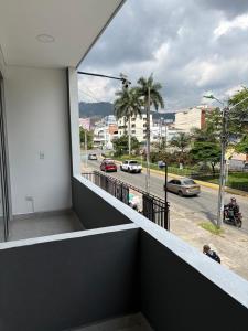 a balcony with a view of a street with cars at alojamientos la martina in Cali