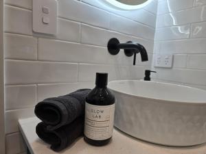 a bottle of wine sitting on a counter next to a sink at Studio with amazing views in Russell
