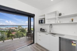 a kitchen with a view of the ocean at Studio with amazing views in Russell +4 photos