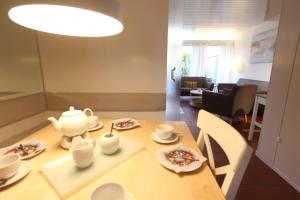 a table with a tea set on top of it at Blaue Dören in Langeoog