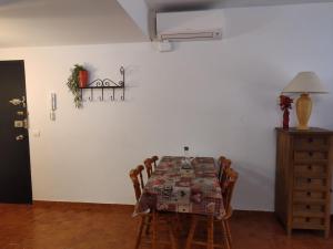 a dining room with a table and chairs at porta del golf in Pals +24 photos