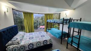 a bedroom with two bunk beds and a window at Finca Casa Real la Vega in La Vega +94 photos