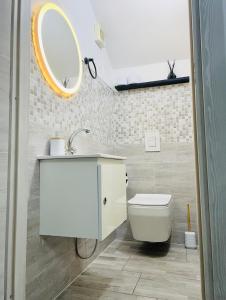 a bathroom with a white toilet and a mirror at Villa Felix in Omegna +32 photos