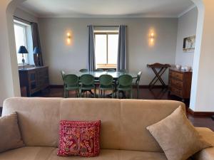 a living room with a couch and a table and chairs at Panoramic XL Penthouse Sliema Seafront in Sliema