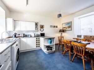 a kitchen and dining room with a table and chairs at The Old Library, Brora in Brora