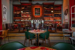 a restaurant with tables and chairs and a bar at The Social Hub Florence Belfiore in Florence +43 photos
