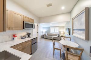 a kitchen and living room with a table and a couch at The Palmetto Inn in Boca Grande +54 photos