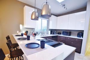 a kitchen with a white counter top and a stove at Lighted Pool Nights Fenced Yard & Mountain View in Tucson