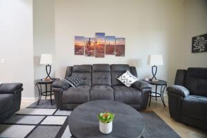 a living room with a couch and a table at Lighted Pool Nights Fenced Yard & Mountain View in Tucson