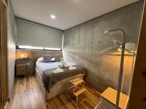 a small bedroom with a bed and a shower at Caniçal houses - Madeira in Caniçal