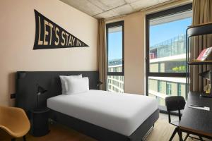 a bedroom with a white bed and a window at The Social Hub Rome in Rome