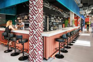 a bar with a red and white patterned wall at The Social Hub Vienna in Vienna