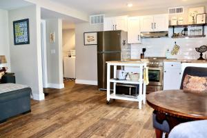 a kitchen with a refrigerator and a table in a room at Charming 1 bedbath Suite in waterfront Cottage in Somers +9 photos