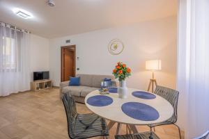 a living room with a table and a couch at PRESTIGE Apartments - Blue Serenity in Verona