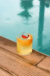 a drink sitting on a table next to a swimming pool at The Social Hub Florence Lavagnini in Florence