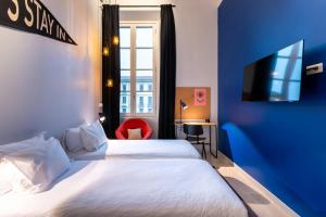 a hotel room with two beds and a tv at The Social Hub Florence Lavagnini in Florence +81 photos