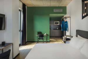 a bedroom with a bed and a green wall at The Social Hub Florence Belfiore in Florence