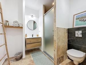 a bathroom with a shower and a toilet and a sink at Cottages Occitans in Villepinte +36 photos