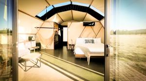 a bedroom with a bed in a tent at Backland Luxury Nature Resort in Williams