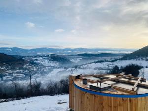 a wooden building on top of a snow covered mountain at Panorama Lupilor in Coleşti