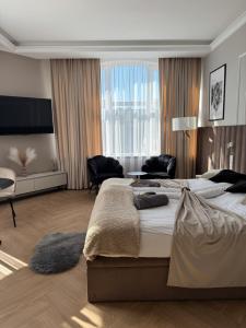 a large bedroom with two beds and a large window at Apartamenty Beauty & SPA in Ełk