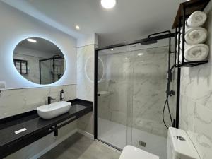 a bathroom with a sink and a mirror at Hotel Lupus Silva in Villardeciervos +24 photos