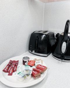 a plate with food on a counter next to a toaster at Central Leith Suite in Edinburgh
