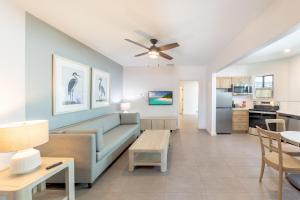 a living room with a couch and a table at The Palmetto Inn in Boca Grande