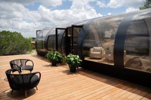 a train on a deck with a table and chairs at Lagom Retreat in Dripping Springs +55 photos