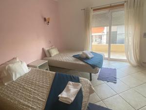 a room with two beds and a window at Lagos Marina Guest House in Lagos