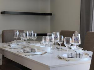a table with wine glasses and plates on it at Sesimbra Horizon in Sesimbra