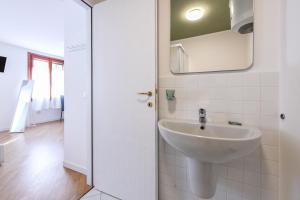 a bathroom with a sink and a mirror at NEW Appartamenti Anna in Sirmione