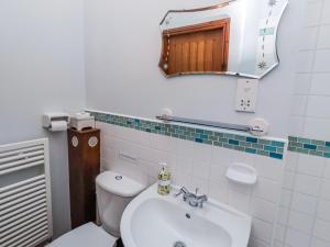 a bathroom with a toilet and a sink and a mirror at No9 Budle Sands in Bamburgh +38 photos