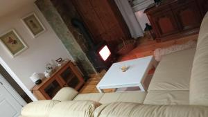 a living room with a couch and a table at Chata Borecké skály in Ktová