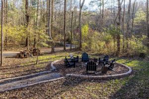 a park with tables and chairs in the woods at Smokies Log Cabin Hot Tub, Fire Pit & Arcade in Townsend