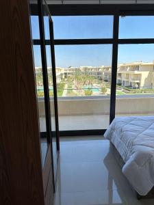 a bedroom with a bed and a large window at Penthouse El Gouna, Hurghada in El Gouna