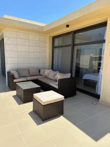 a patio with a couch and tables on a building at Penthouse El Gouna, Hurghada in El Gouna