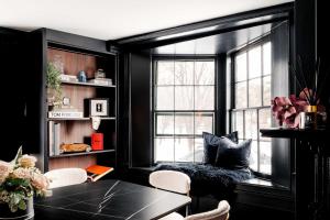 a black room with a table and a window at Garden Gables in Lenox