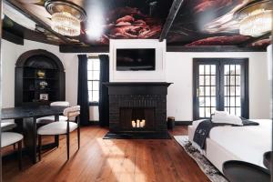 a living room with a fireplace and a tv at Garden Gables in Lenox