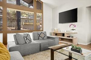 a living room with a couch and a flat screen tv at High Pines Lodge in Flagstaff