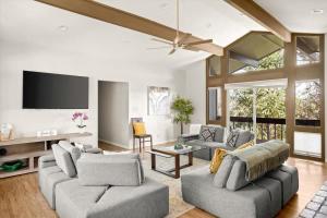 a living room with two couches and a flat screen tv at High Pines Lodge in Flagstaff