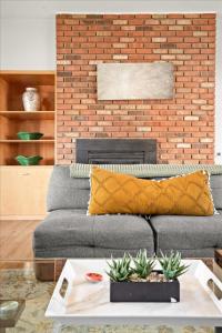 a living room with a couch and a brick wall at High Pines Lodge in Flagstaff