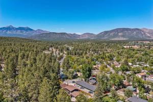 an aerial view of a town with trees and mountains at High Pines Lodge in Flagstaff +48 photos
