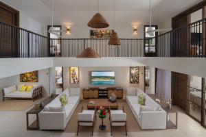 an overhead view of a living room with white furniture at Half Moon in Montego Bay