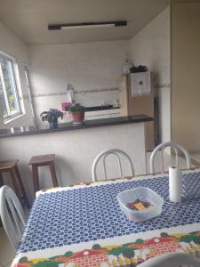 a kitchen with a table with a bowl of food on it at Casa Azul in Carrancas
