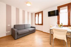 a living room with a couch and a table at Anna Home View in Sirmione