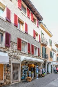 a building with colorful shutters on the side of it at Anna Home View in Sirmione